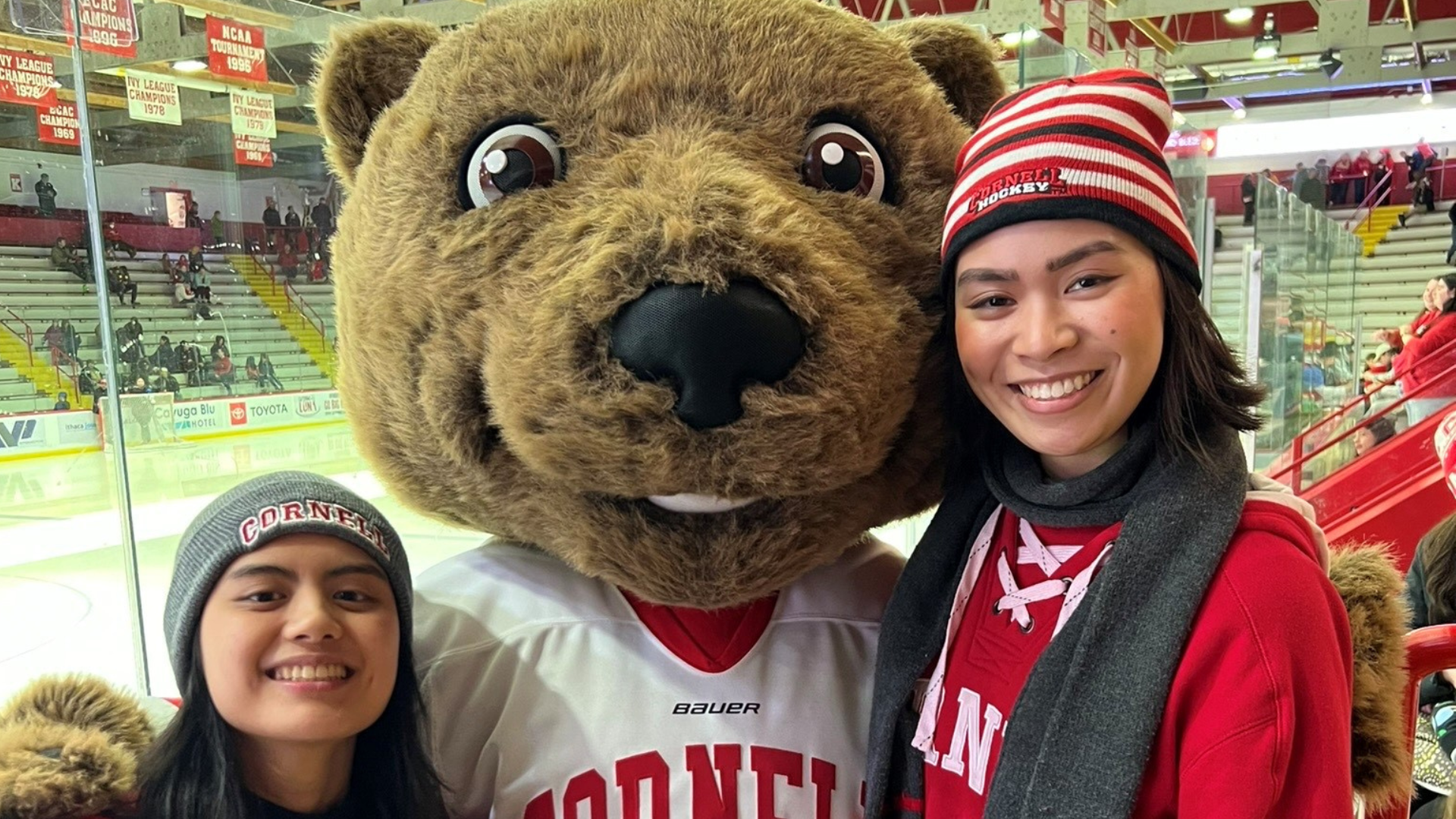 Friends pose with Touchdown at a Cornell hockey game