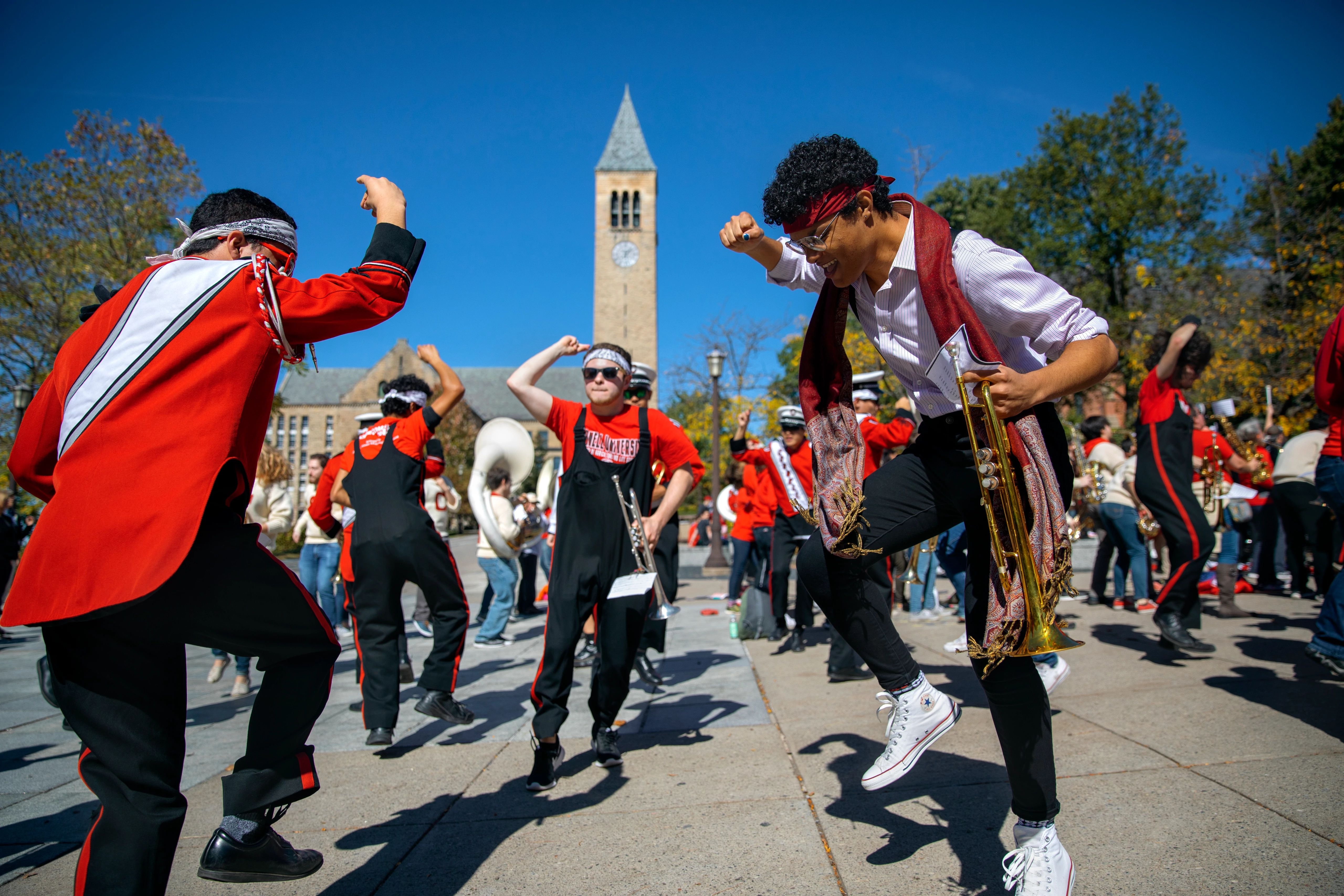 Students playing instruments in Ho Plaza and dancing around